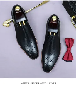Detail of black leather men's hollowed loafers with refined round perforated design