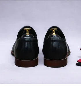 Macro rear view of black leather formal shoe with detailed heel and layered sole texture