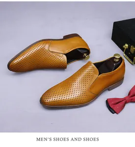 Detail of tan perforated leather loafers with breathable hole design and wooden shoe trees