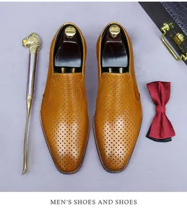 Detailed top view of light brown perforated leather loafers with premium dress accessories