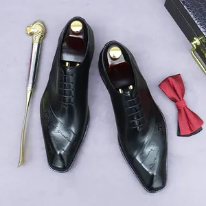 Classic black leather men's dress shoes with artistic engraving and premium accessories