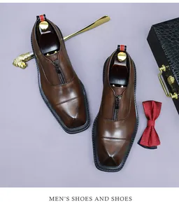 Detail of brown leather men's dress shoes featuring zipper closure and gradient finish