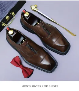 Detail view of brown square-toe leather shoes with metal zipper and premium shoe tree