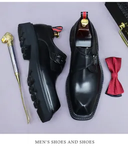 Close-up of black leather monk strap shoe with platform sole and metal buckle detail