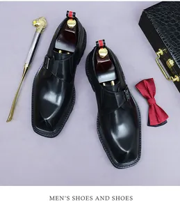 Top view of black leather monk strap shoe with side buckle and elegant accessories