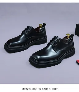 Detail of glossy black leather derby shoes with thick lug sole and lace-up closure