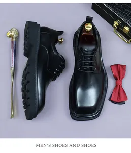 Detailed view of black square-toe leather shoes with thick rubber soles and laces