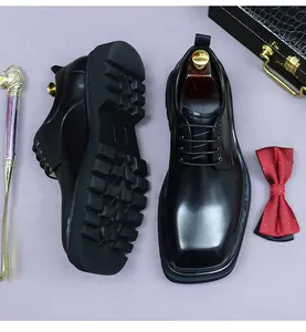 Detailed top view of black square-toe leather shoes with thick platform rubber soles