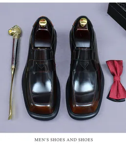 Detailed top view of polished dark brown penny loafers with elegant dress accessories
