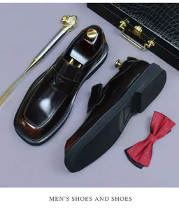 Close-up of polished dark brown leather loafers with non-slip rubber soles and square toes