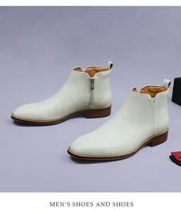 Detail view of cream leather Chelsea boots with side zipper and wood-grain sole