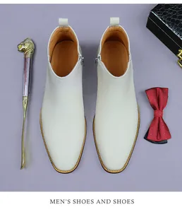 Top view of white leather Chelsea boots for men featuring side zipper and stitch detail