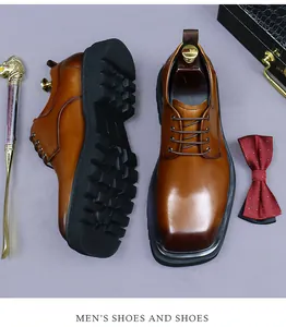 Detail of brown leather derby shoes with lug sole and a luxury golden shoehorn