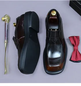Macro detail of glossy brown gradient leather loafers with classic square toe and buckle