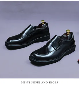 Detailed view of black patent leather men's penny loafers with thick rubber soles