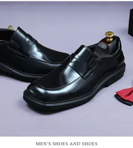 Close-up of black polished leather loafers with square toe and textured rubber sole
