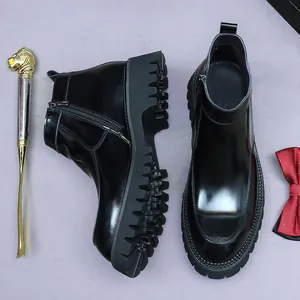 Polished black leather Chelsea boots with thick lug soles and side zipper closure