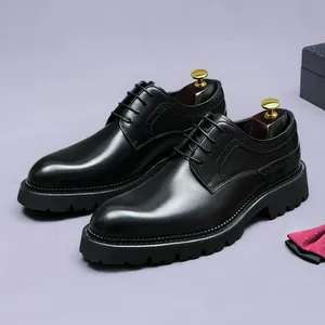 Polished black leather brogue derby shoes with classic wingtip carving and thick lug soles