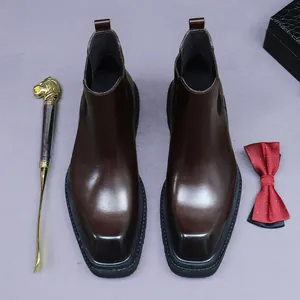 Deep brown leather Chelsea boots for men with lion head shoehorn and polka dot bowtie