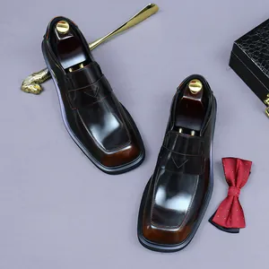 Polished leather penny loafers for men in burgundy with classic wooden shoe trees