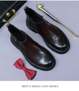 Detail of dark brown leather brogue Chelsea boots with wingtip design and non-slip sole