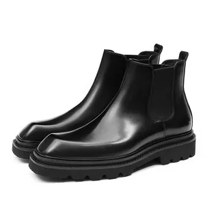 Classic black leather Chelsea boots with thick lug sole and elastic side panels