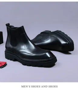 Detail view of premium black leather Chelsea boots with thick rubber lug sole
