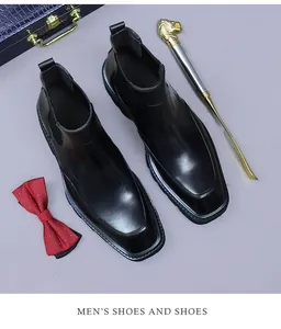 Top view of men's shiny black leather Chelsea boots with a modern square toe design