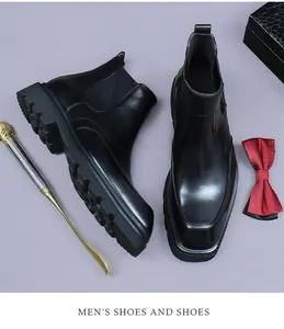 Flat lay of black leather Chelsea boots with square toe and thick lug soles