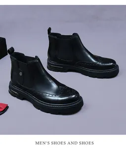 Detail of brogue patterns on black leather chelsea boots with elastic side and lug sole