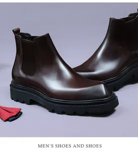 Macro detail of dark brown leather Chelsea boots with elastic sides and platform sole