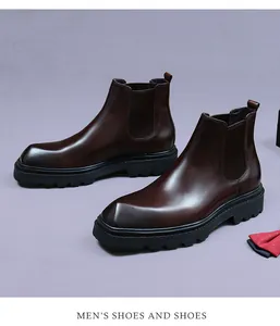 Detailed top view of brown leather Chelsea boots with chunky rubber soles and square toes