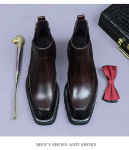 Close-up of polished dark brown leather chelsea boots with square toe and thick sole