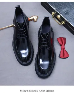 Close-up of black glossy leather boots with classic lace-up and zipper details