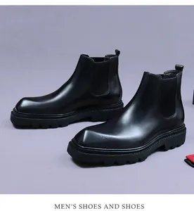 Detailed view of black leather Chelsea boots featuring a thick lug sole and elastic side panels