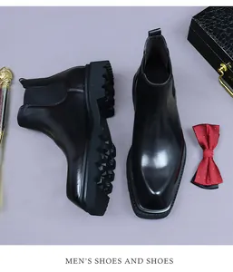 Flat lay of black leather Chelsea boots with chunky soles and formal accessories