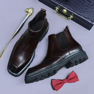Men's dark brown leather Chelsea boots with chunky soles and square toes on display