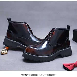 Close-up of polished burgundy leather boots featuring thick rubber lug soles and laces