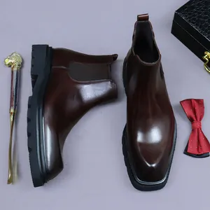 Dark brown leather Chelsea boots with thick soles and premium lifestyle accessories