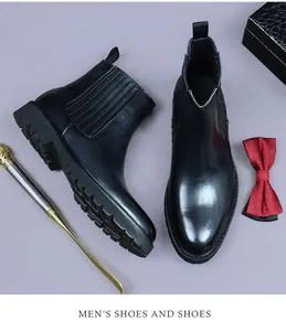 Macro detail of men's leather Chelsea boots with elastic side and thick lugged sole