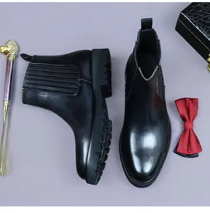 Detail shot of black leather Chelsea boots with elastic side panels and lugged chunky soles