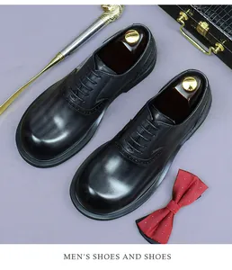Detailed top view of black leather brogue oxford shoes with elegant perforated patterns