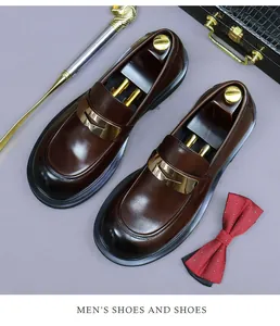 Detail of dark brown leather loafers with gold metal buckle and wooden shoe tree