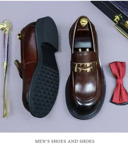 Detail of dark brown leather loafers with gold metal buckle and anti-slip rubber sole