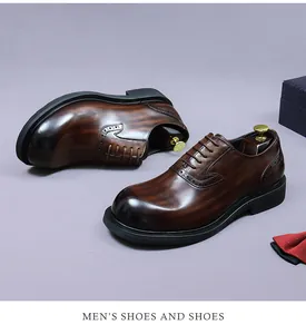 Close-up of premium brown leather oxfords with intricate brogue detailing and patina finish