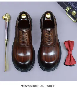 Top view of dark brown leather brogue shoes with decorative bowtie and accessories