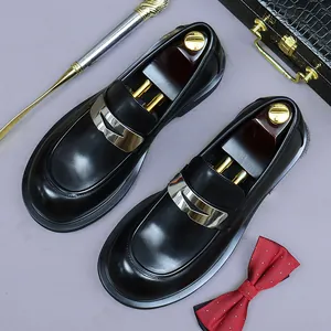 Men's black leather loafers with silver metal buckle on a vintage prop background