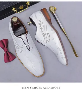 Detailed view of white leather oxford shoes with stylish handwriting and elegant accessories