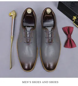 Macro detail of men's leather oxford shoes with elegant script pattern and gradient toe