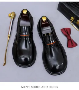 Mocasines de cuero brillante para hombre con detalle naranja y accesorios elegantes